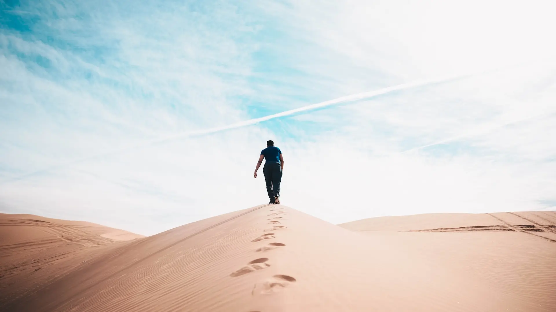 man walking on desert